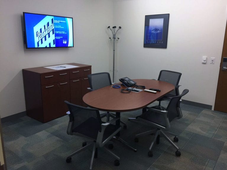Small huddle room with video display and conference phone.